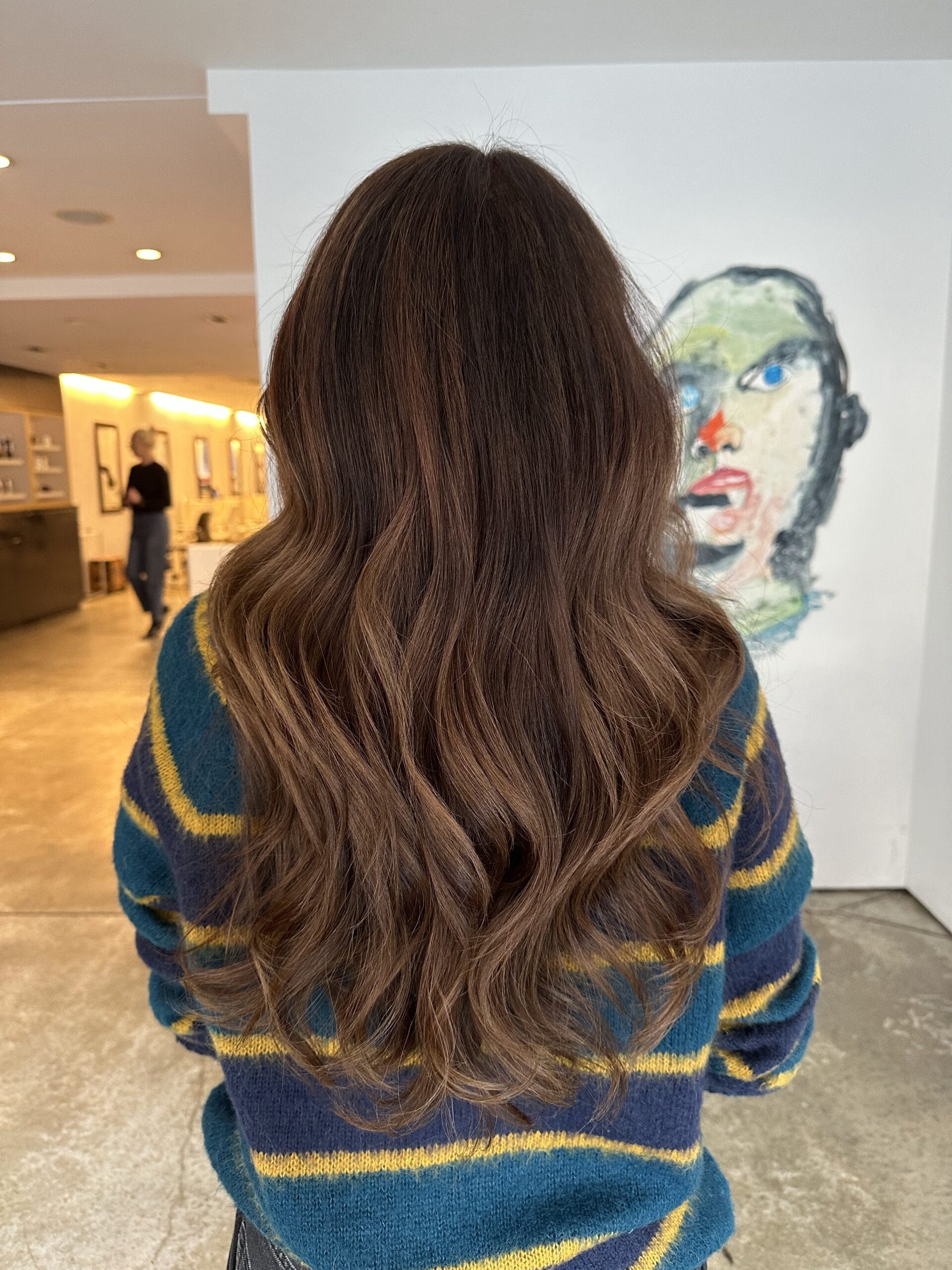Deep chocolate brunette balayage with soft ribbons of warmth and a glossy finish. Perfect for natural-looking dimension and effortless maintenance in NYC.