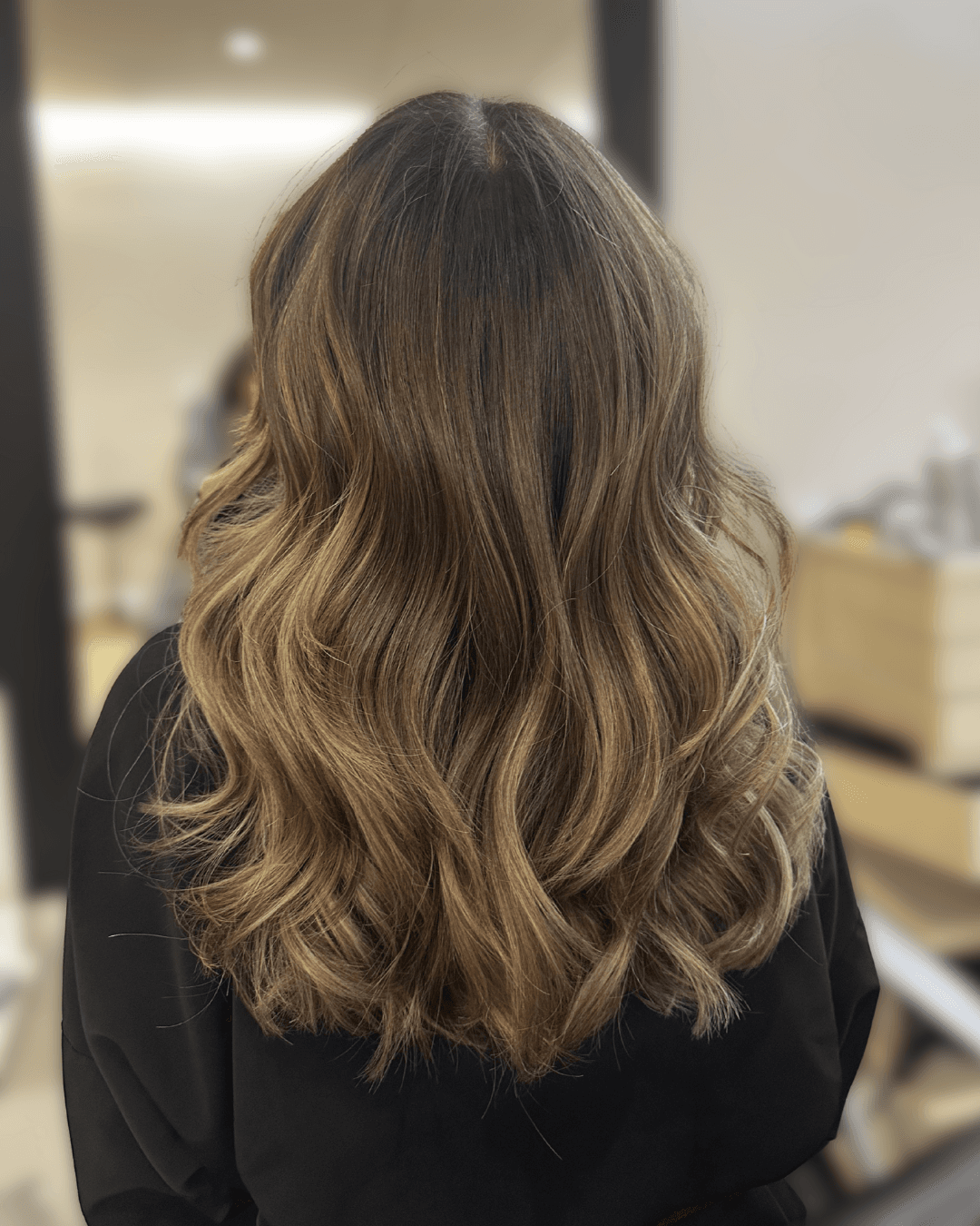 Soft lived-in brunette balayage with blended caramel highlights and natural movement. Low-maintenance dimensional color for an effortlessly luxurious look in NYC. color correction NYC